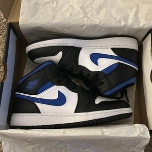 Black, white, and blue Jordan 1’s